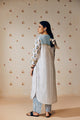 Summer-perfect off-white handwoven khadi cotton tunic featuring blue and mustard flower bunch hand block print, paired with dark blue striped pants; a breathable, handcrafted ethnic co-ord set ideal for warm weather.