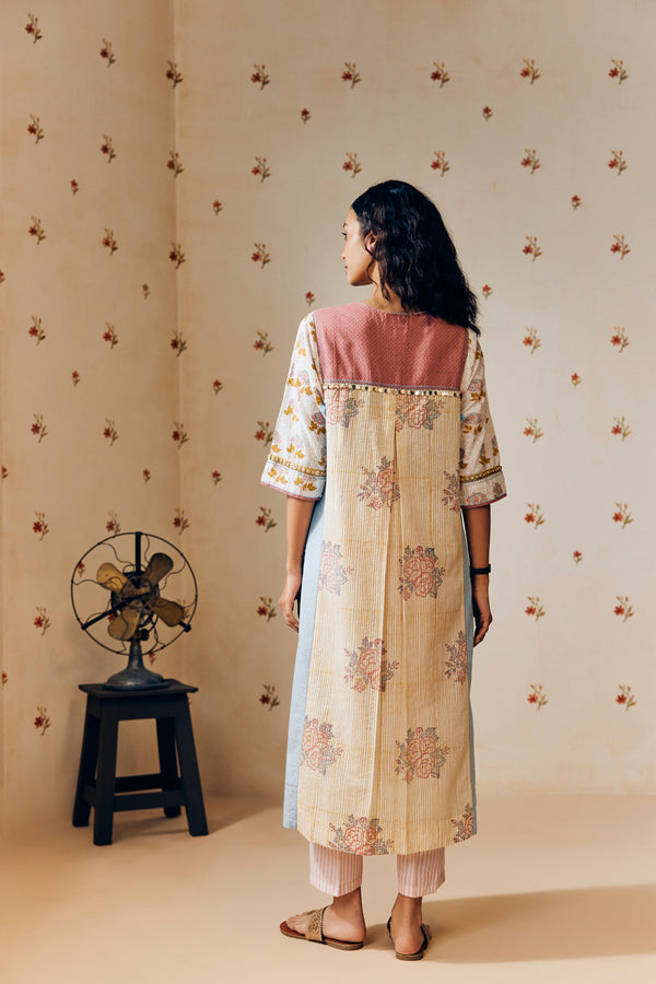 **Alt text:**
Off-white handwoven khadi cotton tunic with mustard and powder pink poppy hand block print, paired with powder pink striped pants; a breezy, handcrafted summer co-ord set made from natural fabric.
