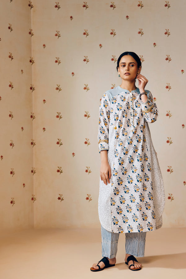Summer-perfect off-white handwoven khadi cotton tunic featuring blue and mustard flower bunch hand block print, paired with dark blue striped pants; a breathable, handcrafted ethnic co-ord set ideal for warm weather.