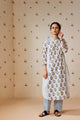 Summer-perfect off-white handwoven khadi cotton tunic featuring blue and mustard flower bunch hand block print, paired with dark blue striped pants; a breathable, handcrafted ethnic co-ord set ideal for warm weather.