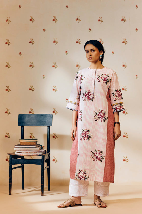 Off-white handwoven khadi cotton tunic with pink rose hand block print, paired with powder pink bandhani dot printed pants; a lightweight, handcrafted co-ord set perfect for summer wear.