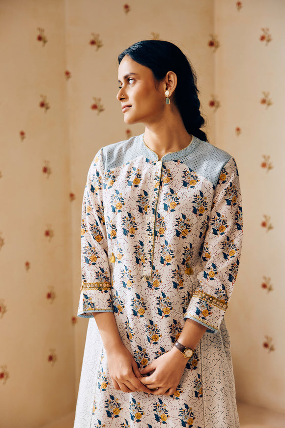 Summer-perfect off-white handwoven khadi cotton tunic featuring blue and mustard flower bunch hand block print, paired with dark blue striped pants; a breathable, handcrafted ethnic co-ord set ideal for warm weather.
