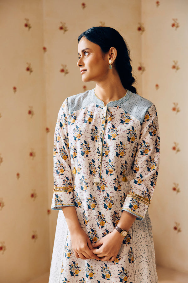 Summer-perfect off-white handwoven khadi cotton tunic featuring blue and mustard flower bunch hand block print, paired with dark blue striped pants; a breathable, handcrafted ethnic co-ord set ideal for warm weather.