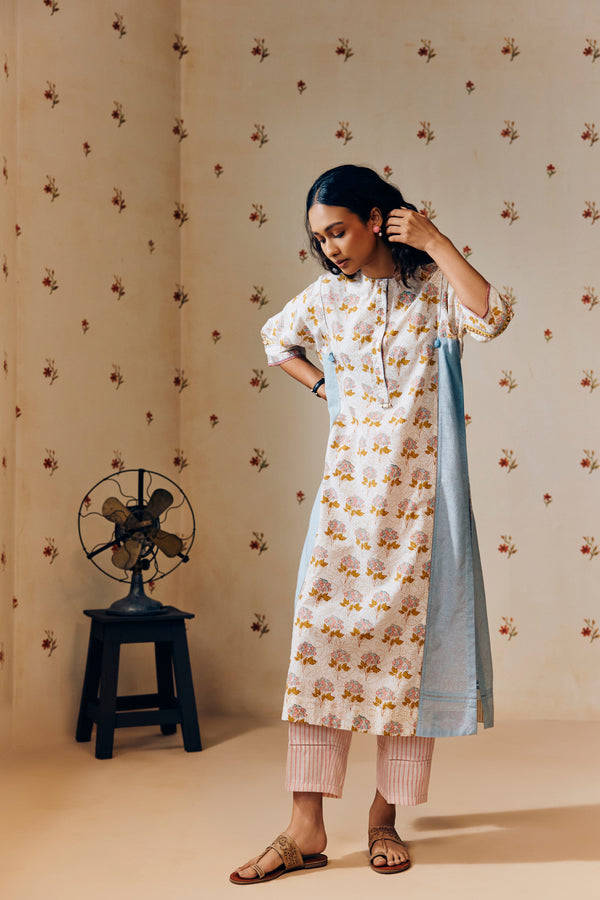 **Alt text:**
Off-white handwoven khadi cotton tunic with mustard and powder pink poppy hand block print, paired with powder pink striped pants; a breezy, handcrafted summer co-ord set made from natural fabric.
