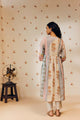 Off-white empire cut tunic set with marigold block prints, inspired by nature and ethically made from soft, breathable fabric for a graceful, sustainable look.