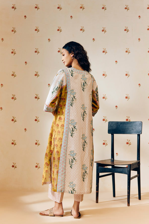 **Alt text:**
Off-white handwoven V-neck cotton mulmul tunic with mustard tulip hand block print, paired with mustard and magenta polka dot printed pants; a breezy, multipanel ethnic co-ord set crafted for comfort and style.
