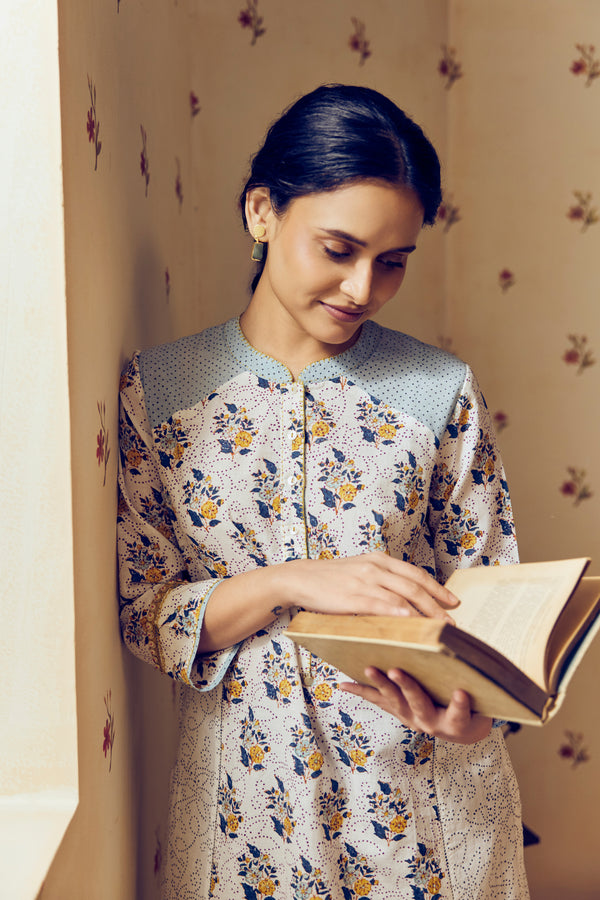 Summer-perfect off-white handwoven khadi cotton tunic featuring blue and mustard flower bunch hand block print, paired with dark blue striped pants; a breathable, handcrafted ethnic co-ord set ideal for warm weather.
