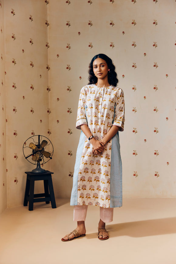 **Alt text:**
Off-white handwoven khadi cotton tunic with mustard and powder pink poppy hand block print, paired with powder pink striped pants; a breezy, handcrafted summer co-ord set made from natural fabric.
