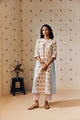 **Alt text:**
Off-white handwoven khadi cotton tunic with mustard and powder pink poppy hand block print, paired with powder pink striped pants; a breezy, handcrafted summer co-ord set made from natural fabric.
