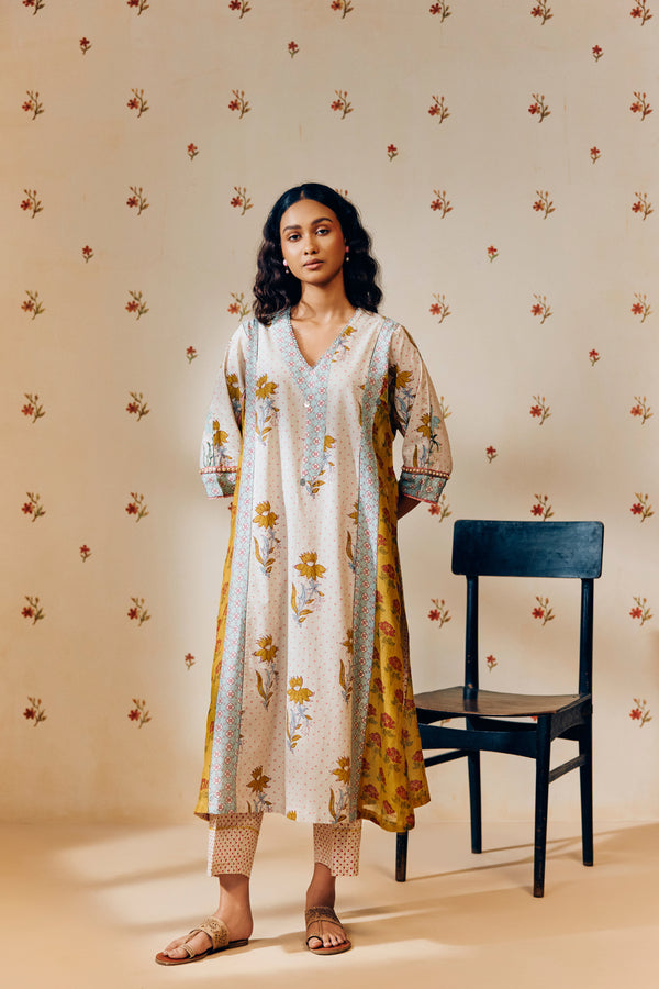 **Alt text:**
Off-white handwoven V-neck cotton mulmul tunic with mustard tulip hand block print, paired with mustard and magenta polka dot printed pants; a breezy, multipanel ethnic co-ord set crafted for comfort and style.
