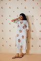 Off-white handwoven khadi cotton tunic with sky blue and pink rose hand block print, paired with mustard bandhani dot printed pants; a handcrafted summer co-ord set made from breathable, natural fabric.
