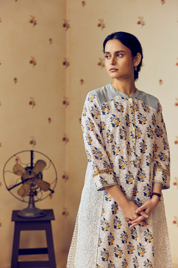 Summer-perfect off-white handwoven khadi cotton tunic featuring blue and mustard flower bunch hand block print, paired with dark blue striped pants; a breathable, handcrafted ethnic co-ord set ideal for warm weather.