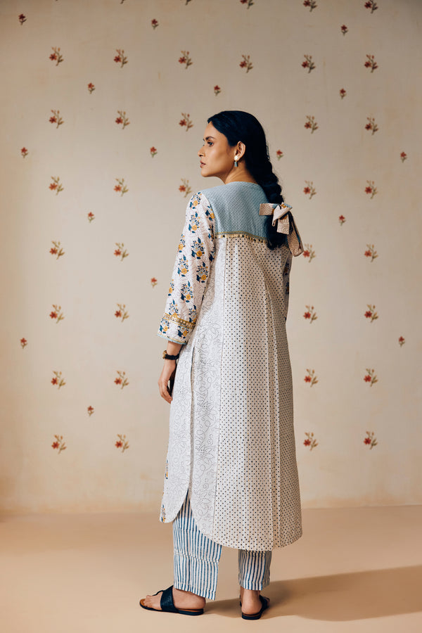 Summer-perfect off-white handwoven khadi cotton tunic featuring blue and mustard flower bunch hand block print, paired with dark blue striped pants; a breathable, handcrafted ethnic co-ord set ideal for warm weather.